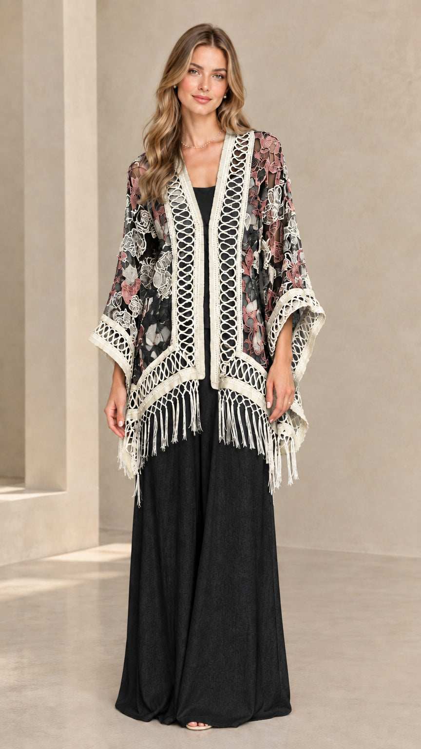 Woman wearing black floral lace fringe kimono cardigan with black pants