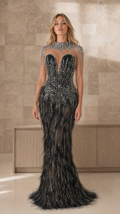 Front view of black beaded illusion feather evening gown