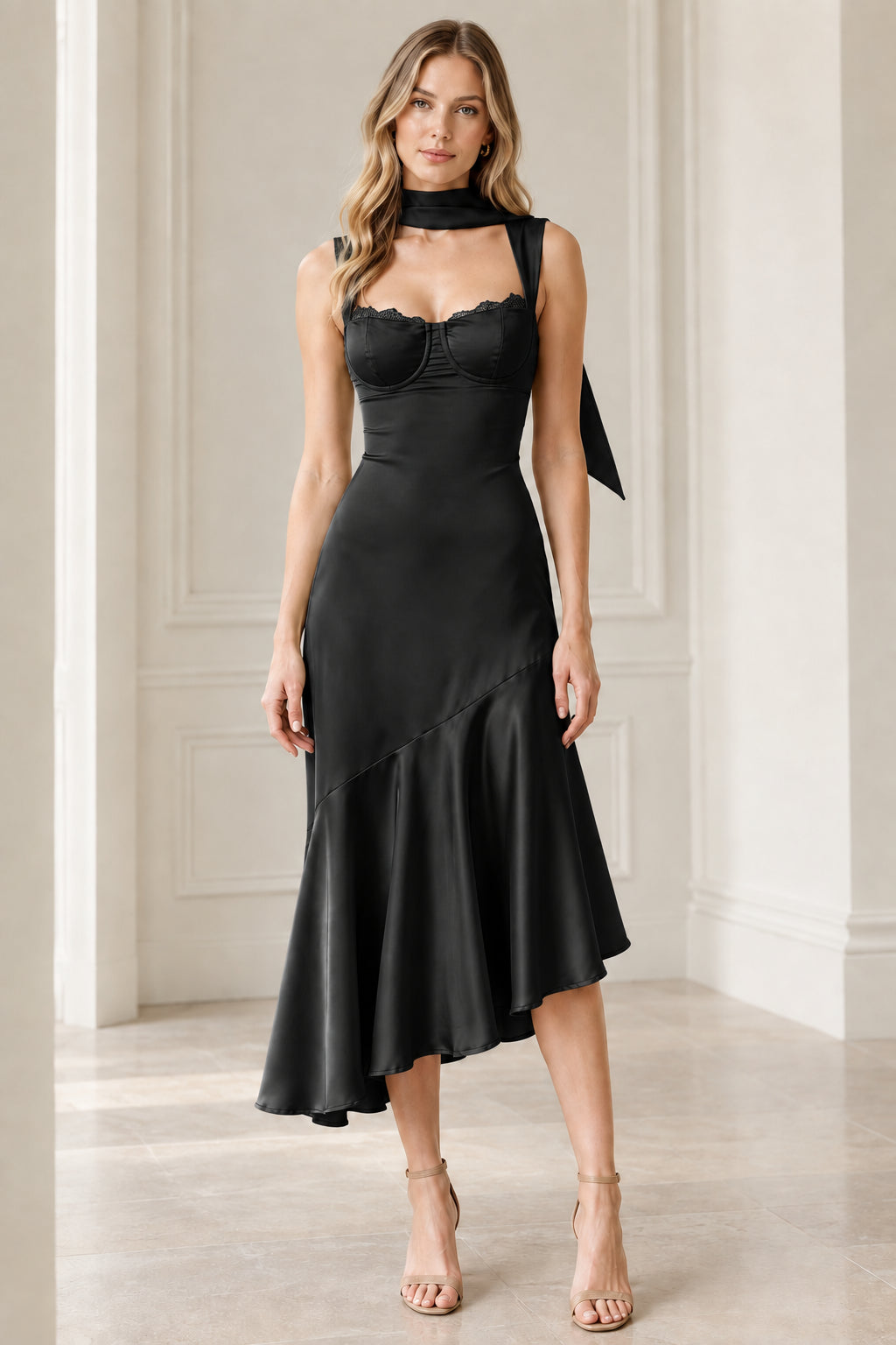 Full-length front view of black satin bustier asymmetrical midi dress with scarf
