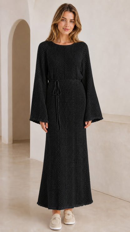 Front view of model wearing black textured knit bell sleeve maxi dress