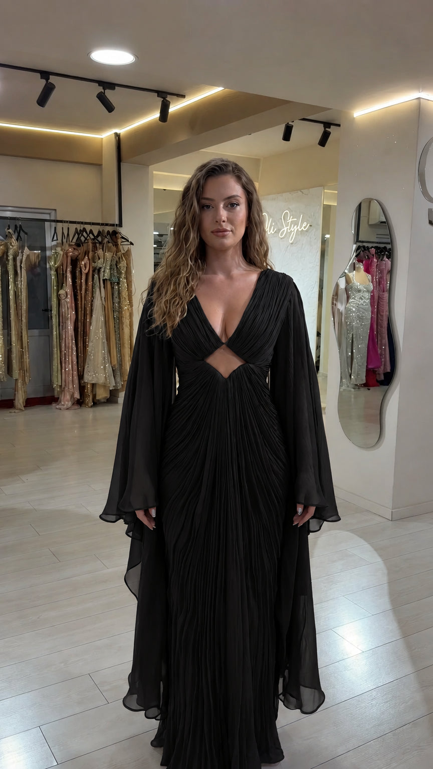 Black pleated deep V-neck maxi gown with dramatic cape sleeves