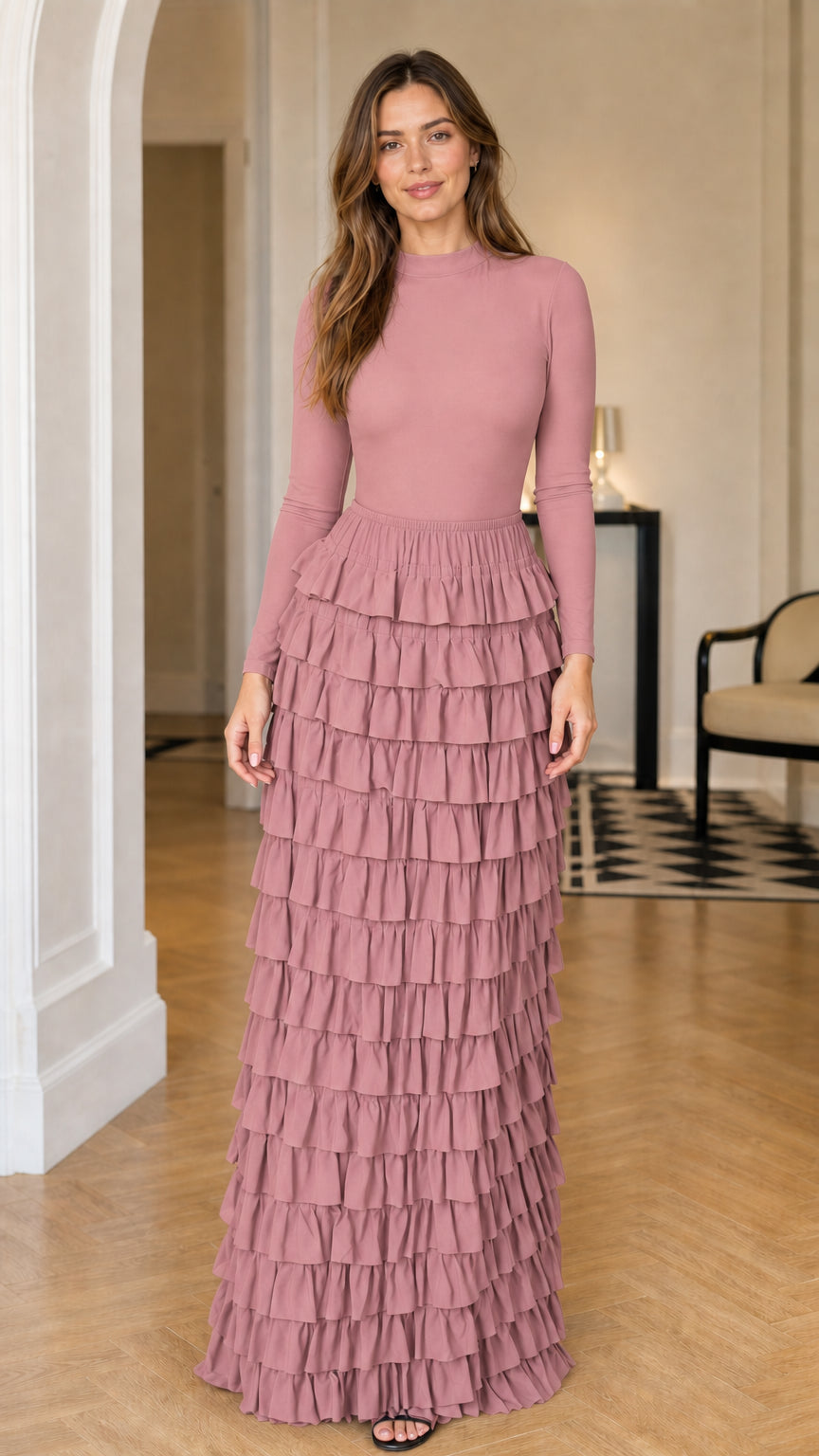Full front view of a woman wearing a dusty pink mock neck tiered ruffle maxi dress