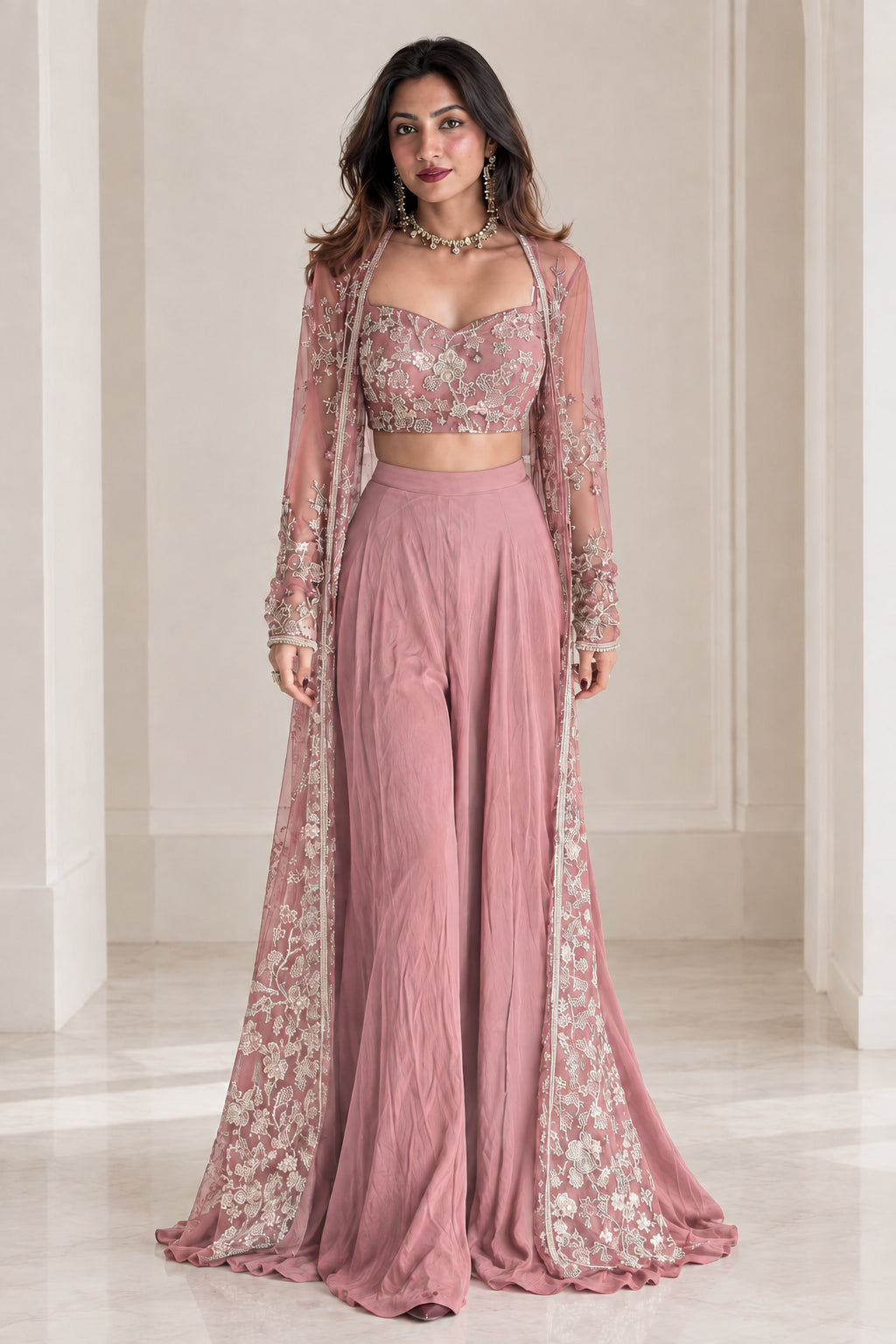 Model wearing dusty pink embroidered 3-piece palazzo set with matching sheer cape jacket