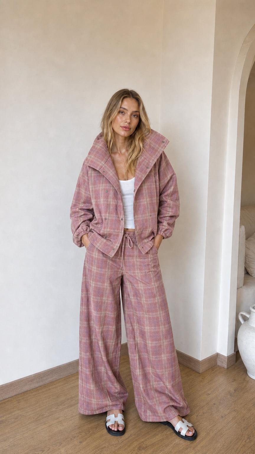 Model wearing dusty pink plaid high-collar jacket and matching wide-leg lounge pants