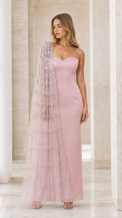 Model wearing blush pink strapless maxi dress with sparkling cape overlay