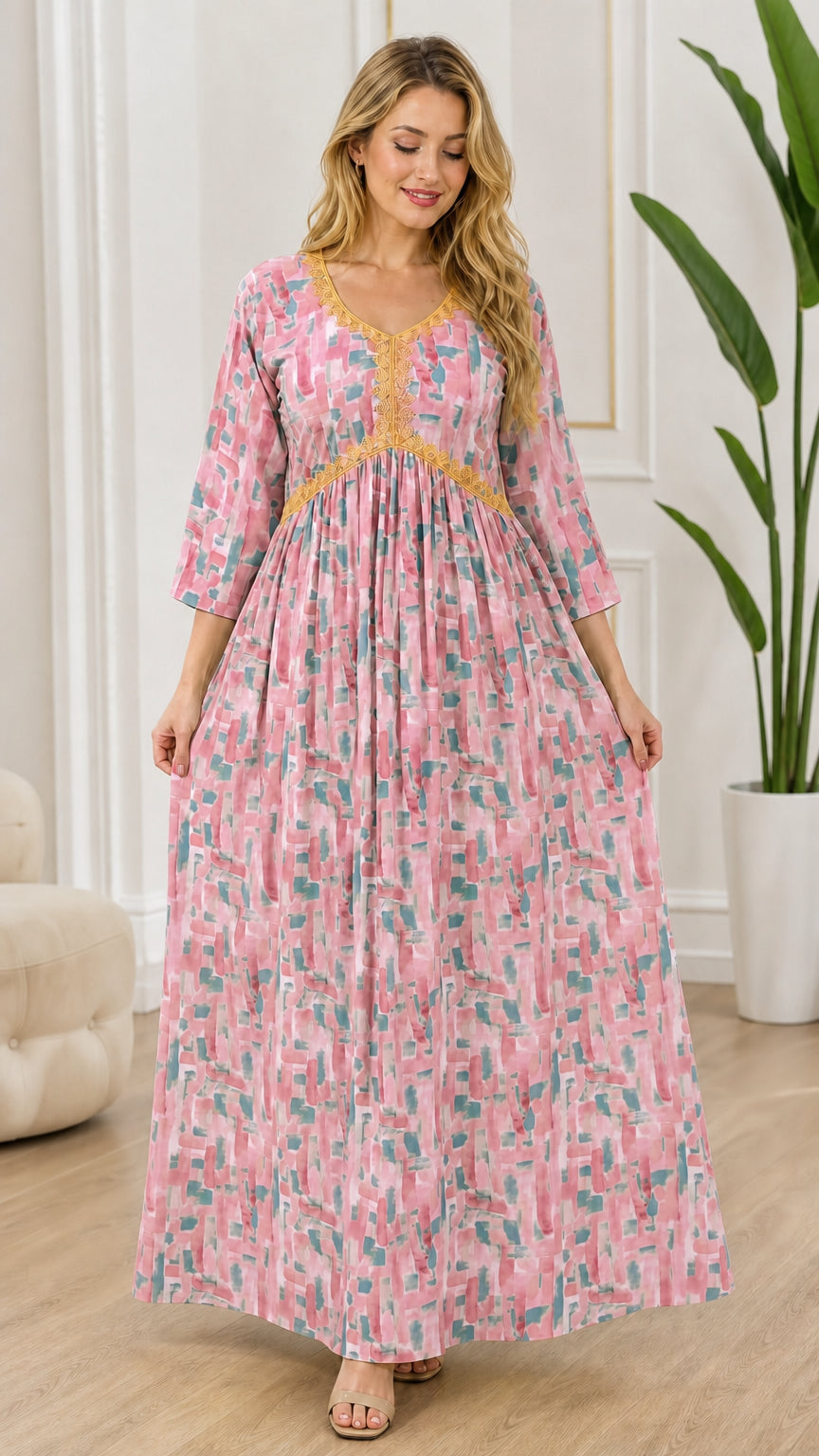 Full-length front view of model wearing soft pink and multi-colored abstract print maxi dress