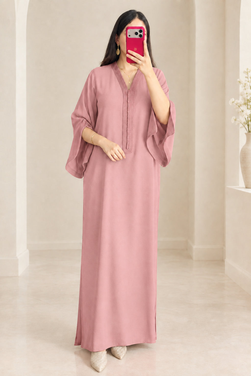 Front view of woman wearing dusty pink kaftan maxi dress with draped sleeves