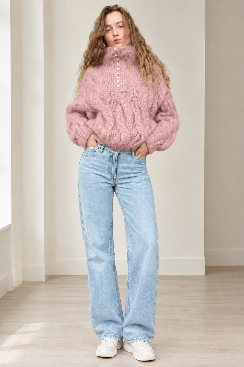 Model wearing dusty pink chunky cable knit button high neck sweater