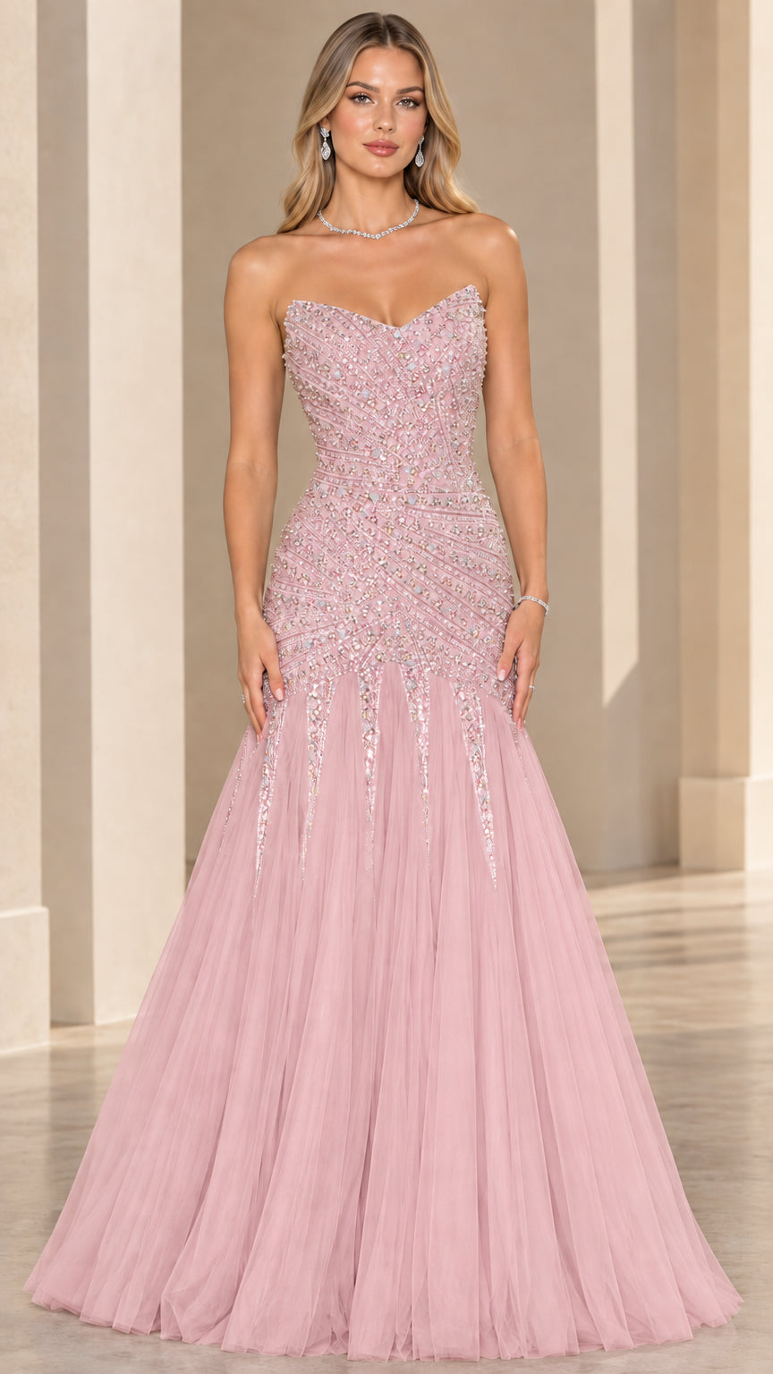 Front view of model wearing blush pink strapless beaded mermaid formal gown