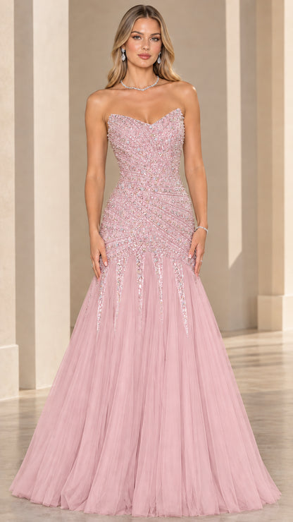 Front view of model wearing blush pink strapless beaded mermaid formal gown