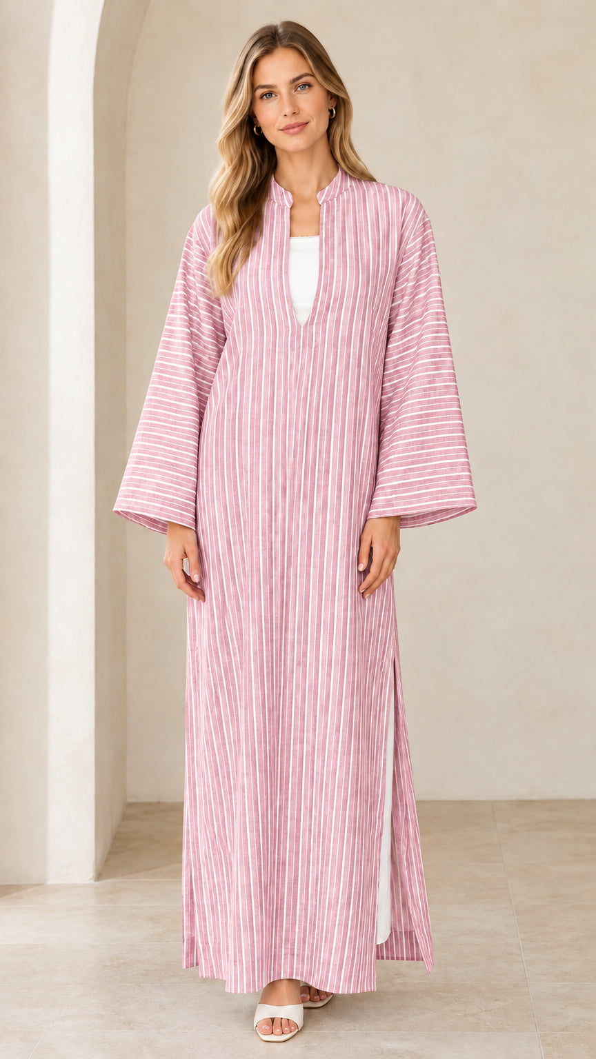 Woman wearing pink vertical striped maxi kaftan dress