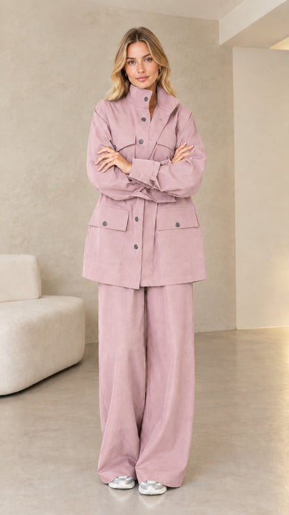 Model wearing soft dusty pink matching utility jacket and pants set