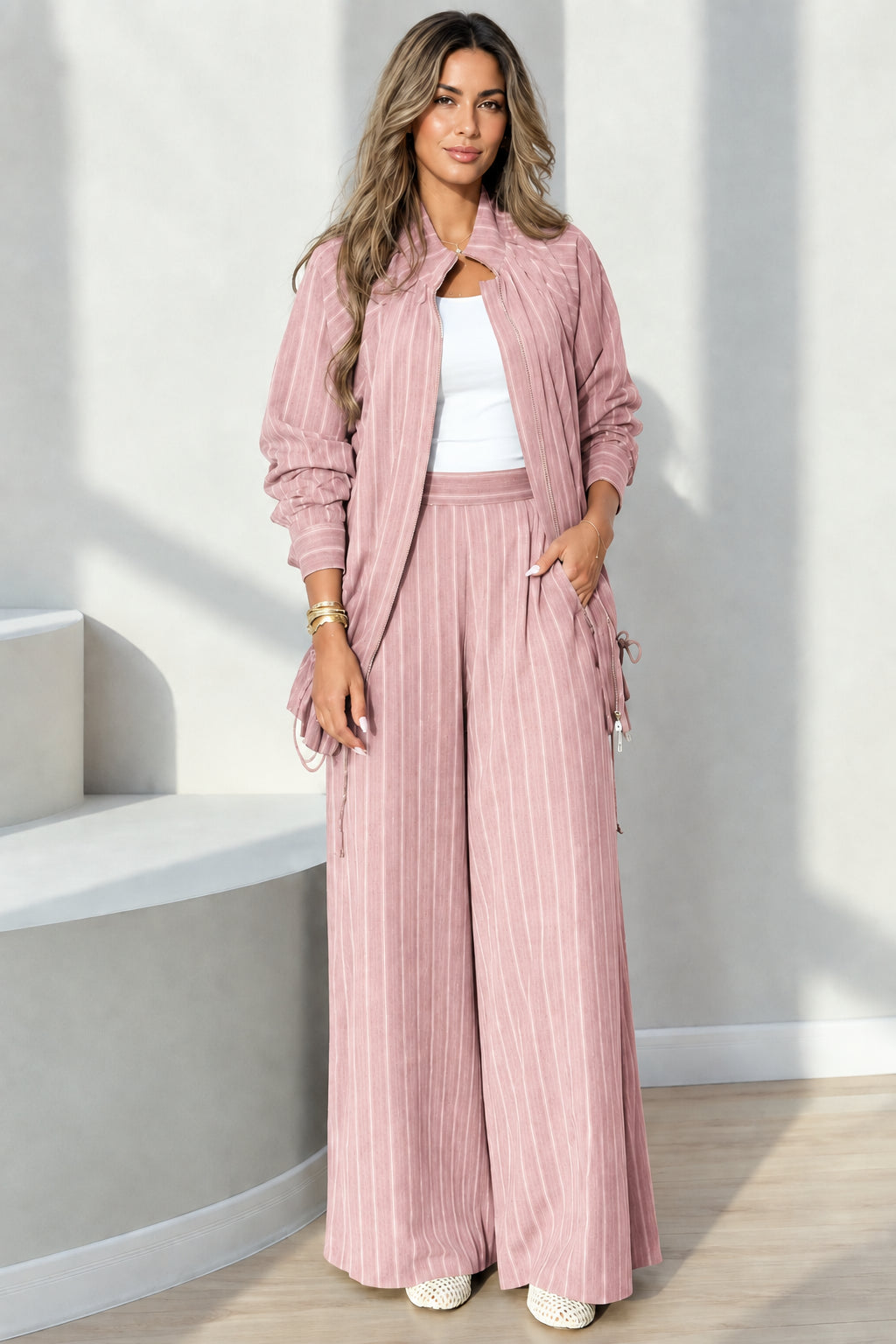 Full-length view of dusty pink pinstripe jacket and trousers two-piece set