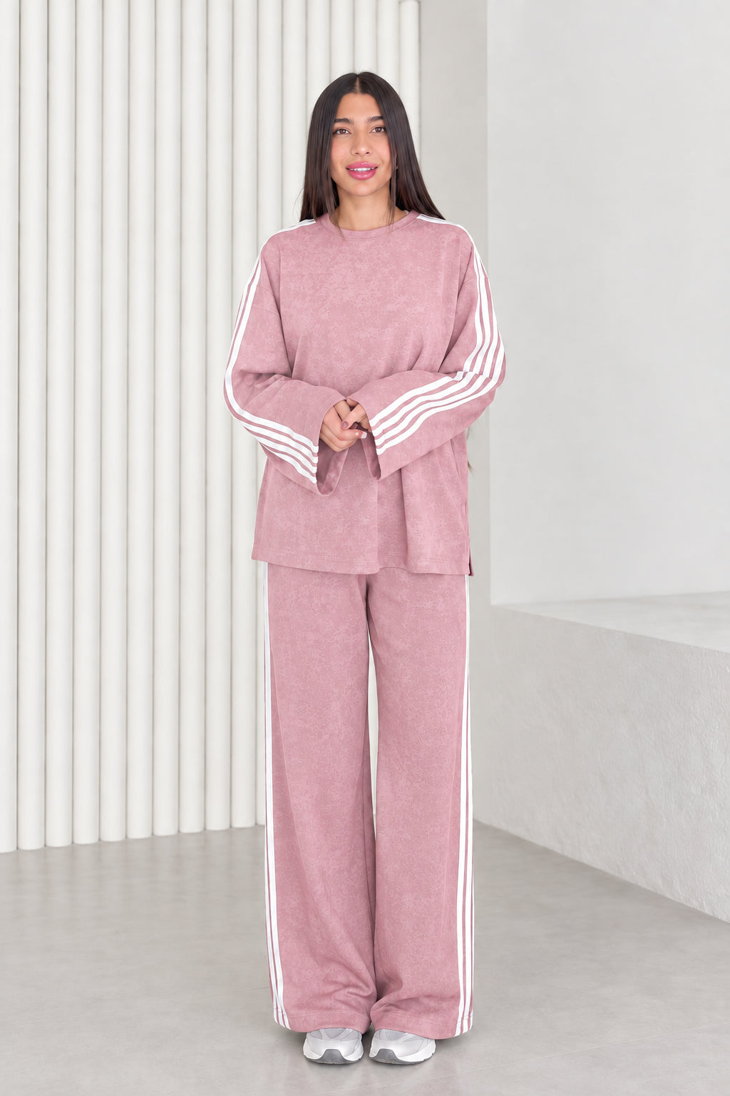 Full length view of model wearing dusty pink two-piece striped tracksuit set