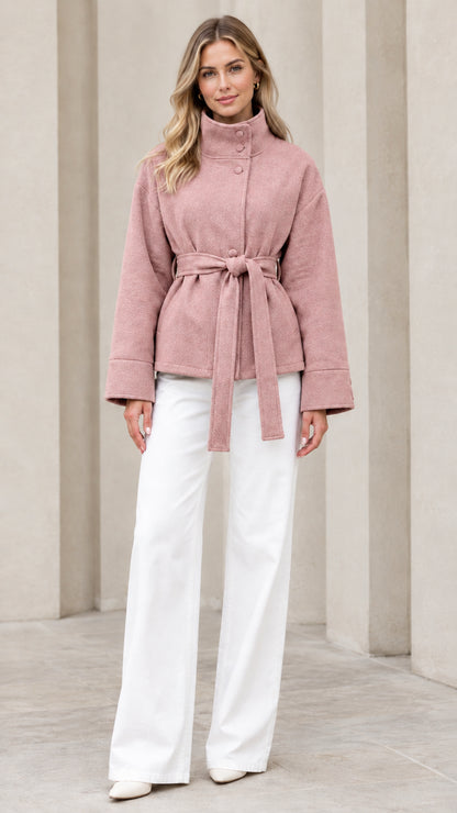 Front view of model wearing dusty pink stand collar belted short coat