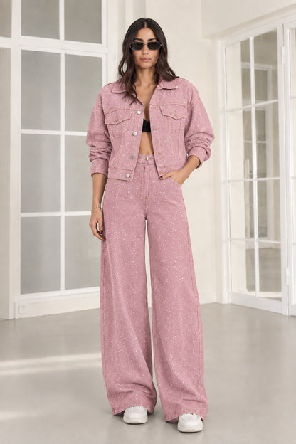 Model wearing dusty pink rhinestone denim cropped jacket and matching wide-leg trousers