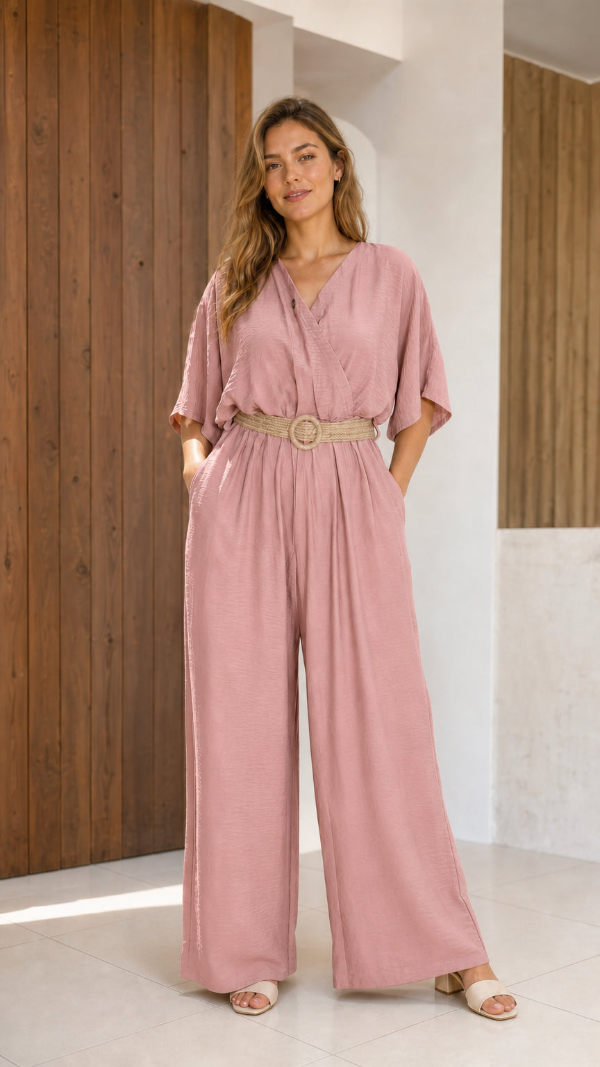 Woman wearing dusty pink wide-leg v-neck jumpsuit with woven belt