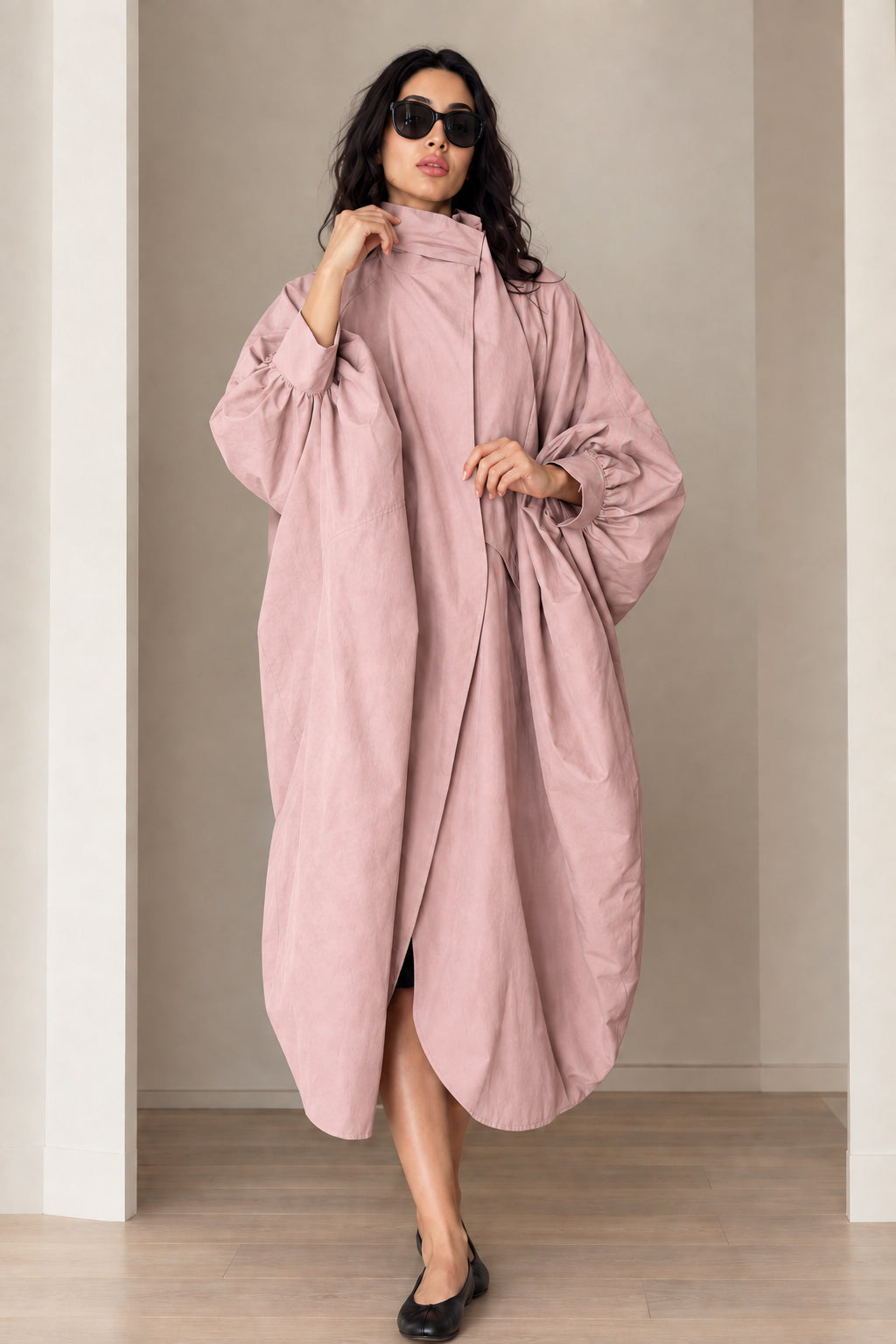 Model wearing dusty pink oversized balloon sleeve cocoon trench coat