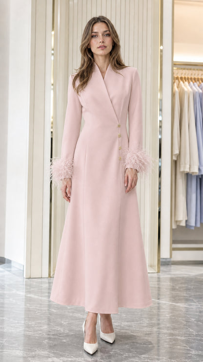 Model wearing Blush Pink long-sleeve coat dress with feather cuffs and gold buttons