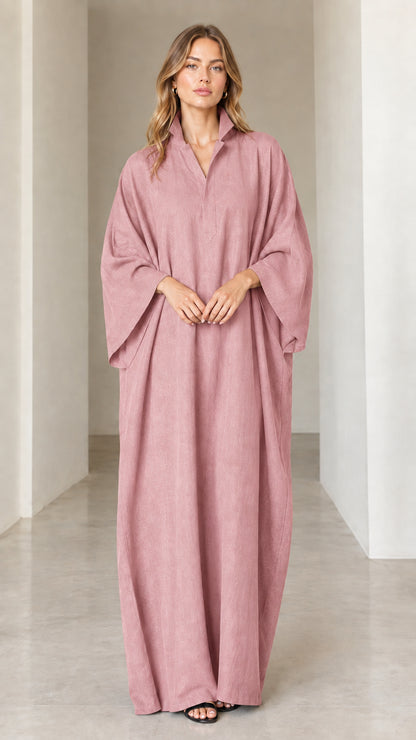 Model wearing dusty rose pink oversized collared maxi kaftan dress