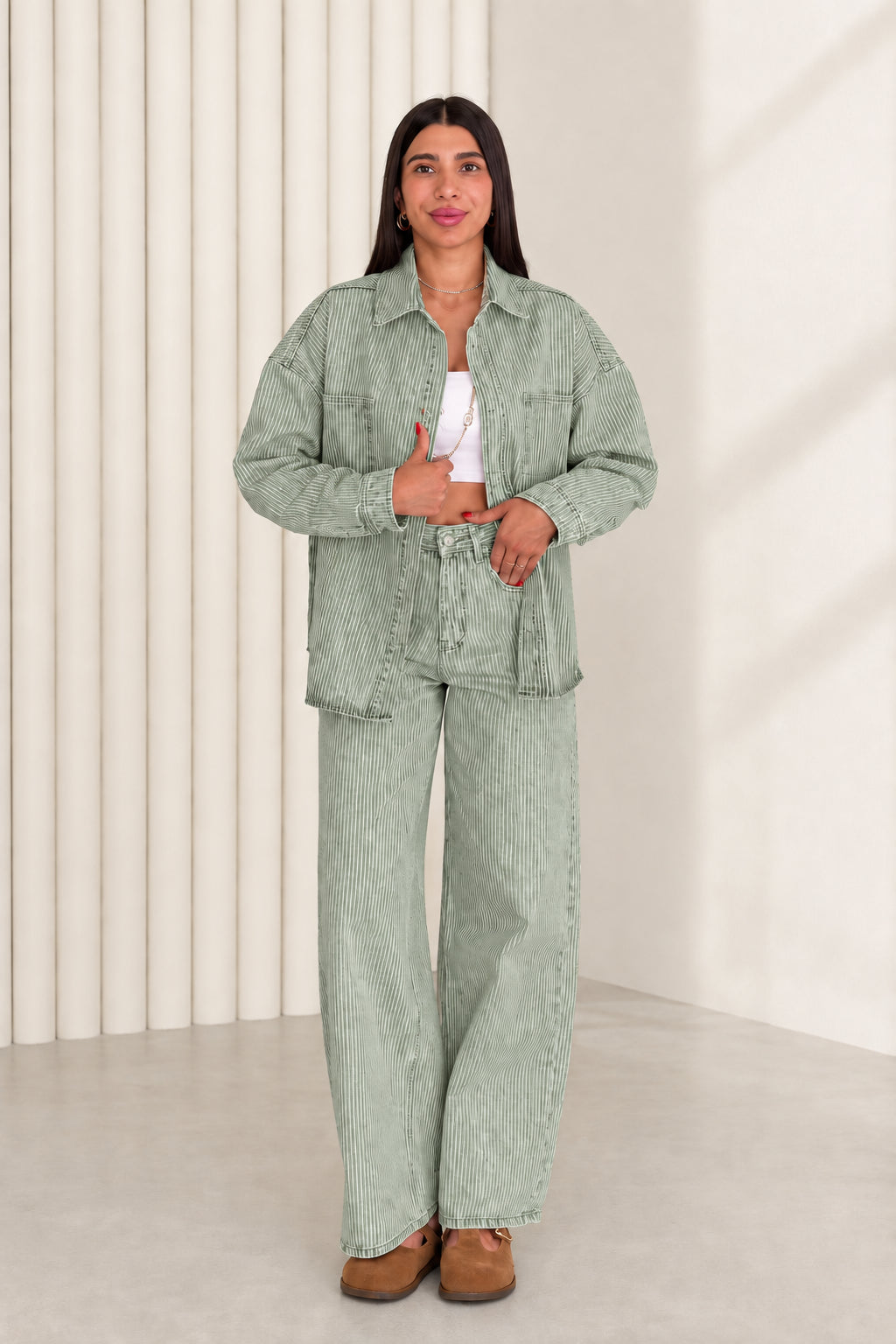 Model wearing sage green striped denim shacket and wide leg pants set
