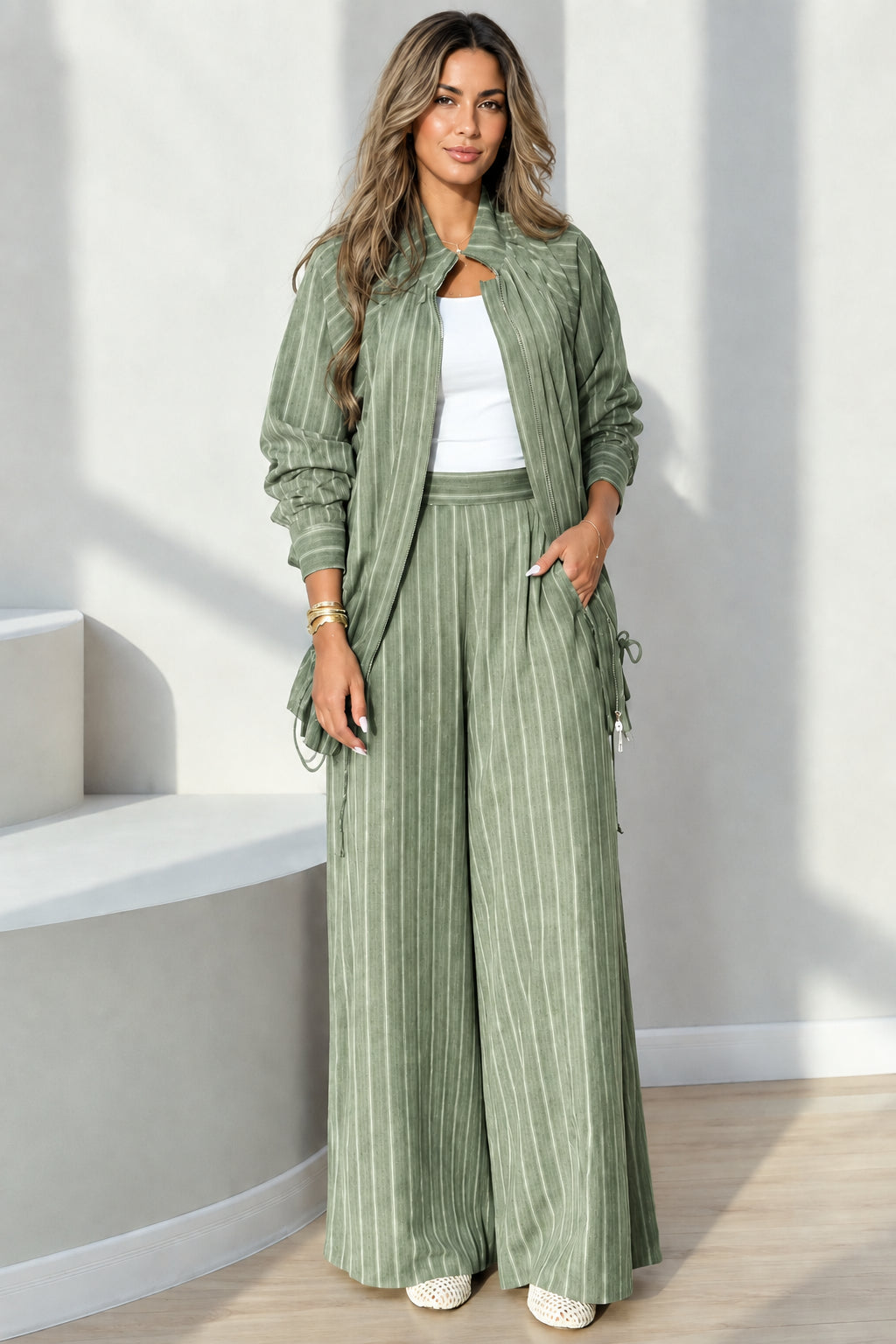 Full-length view of sage green pinstripe zip-front top and wide-leg pants set