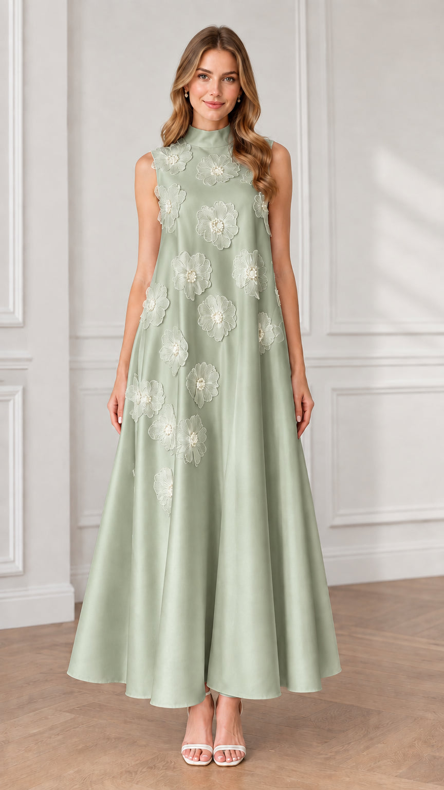 Model wearing sage green sleeveless high neck maxi dress with white floral appliqués