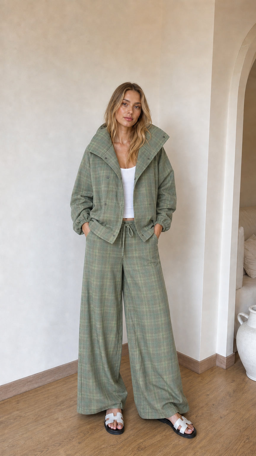 Model wearing sage green plaid two-piece high-neck jacket and wide-leg pant set
