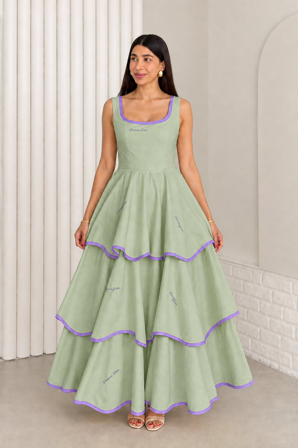 Model wearing sage green sleeveless tiered maxi dress with purple contrast trim