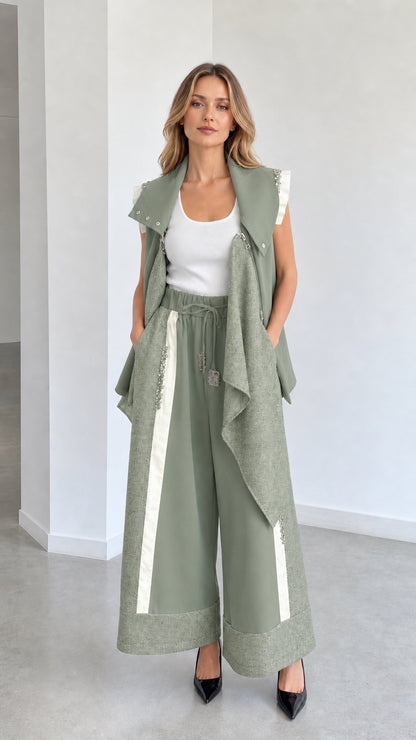 Sage green two-piece outfit with sleeveless draped gilet and wide-leg culottes