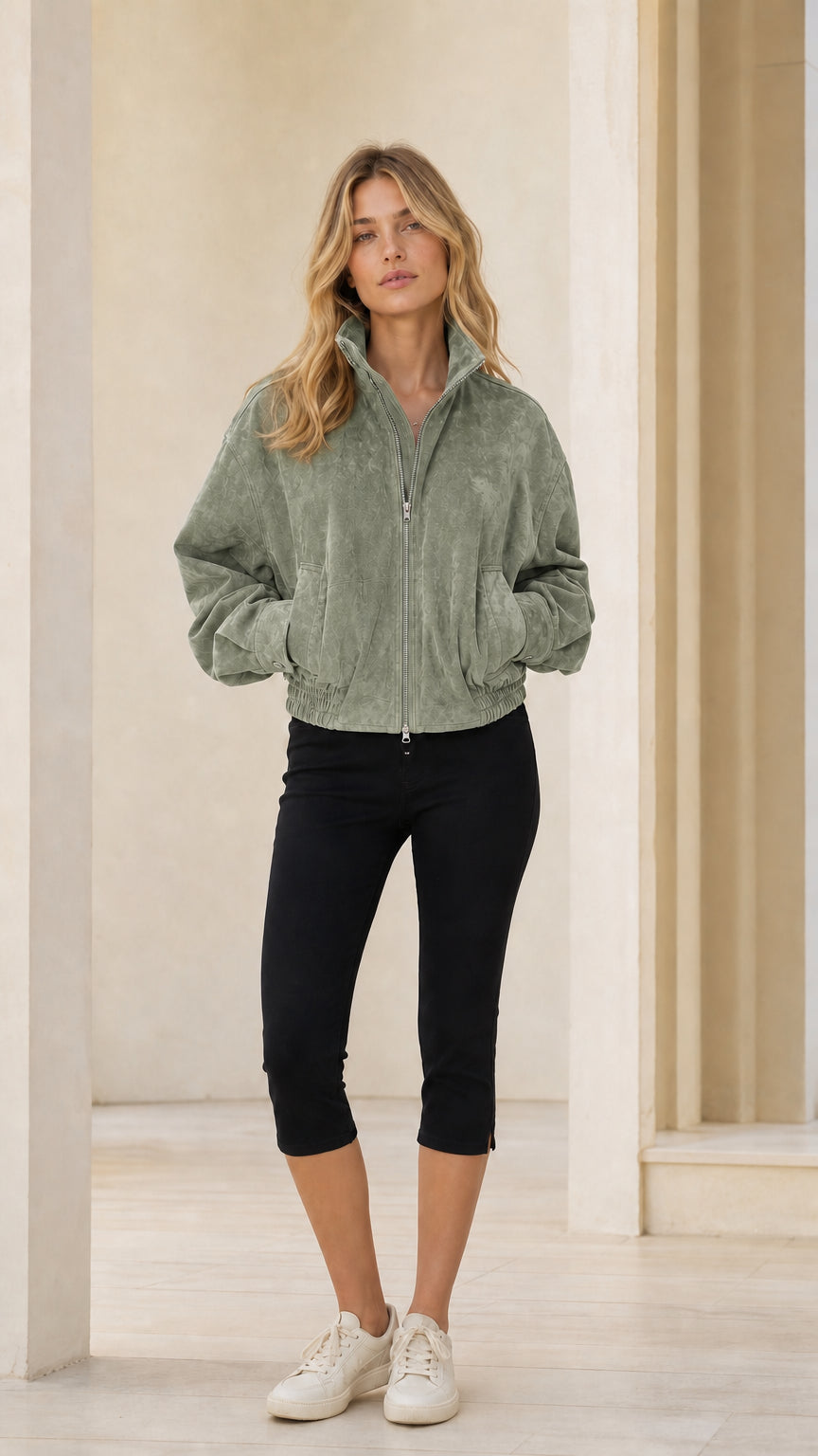 Woman wearing sage green full-zip bomber jacket