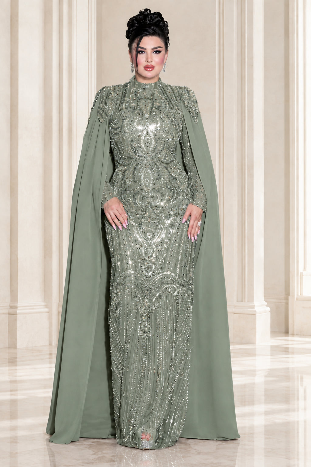 Model wearing sage green sequin beaded high neck cape evening gown