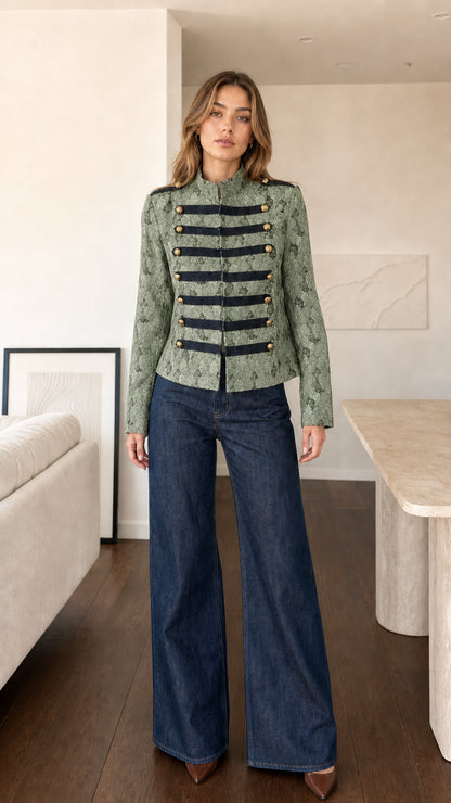 Front view of model wearing Sage Green woven military band jacket with black trim