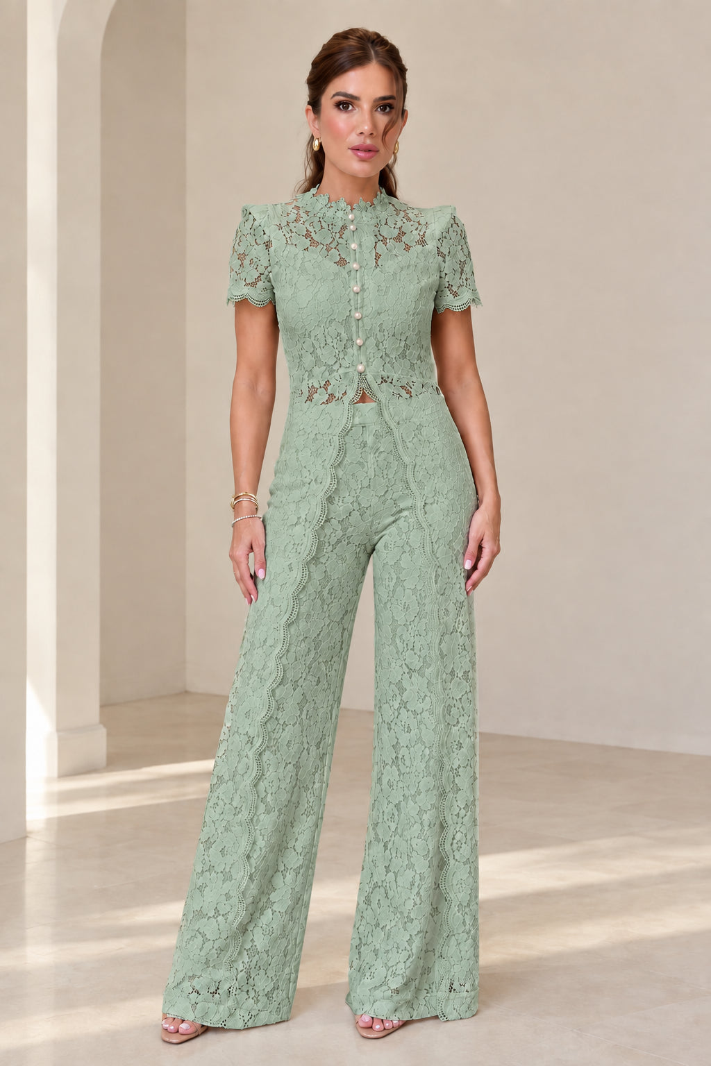 Model wearing sage green floral lace top and wide-leg trousers set