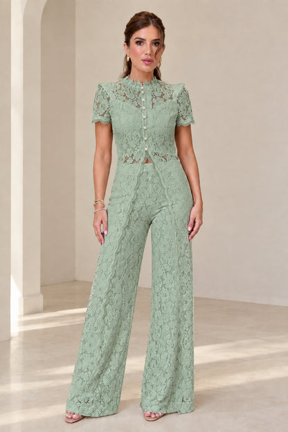 Model wearing sage green floral lace top and wide-leg trousers set