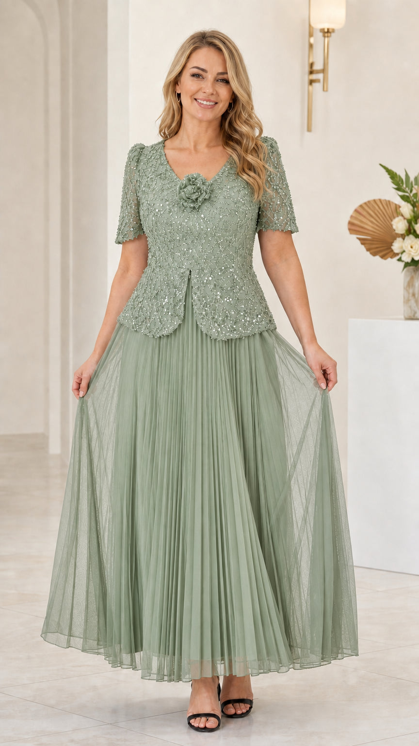 Front view of sage green sequin floral applique pleated evening gown