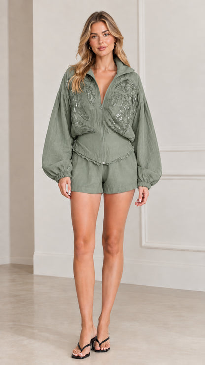 Full front view of women's sage green embellished zip jacket and shorts set