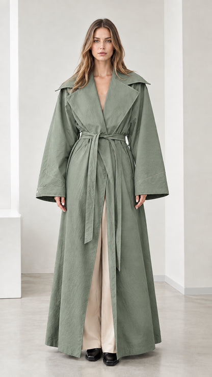 Full-length view of woman wearing sage green maxi trench coat