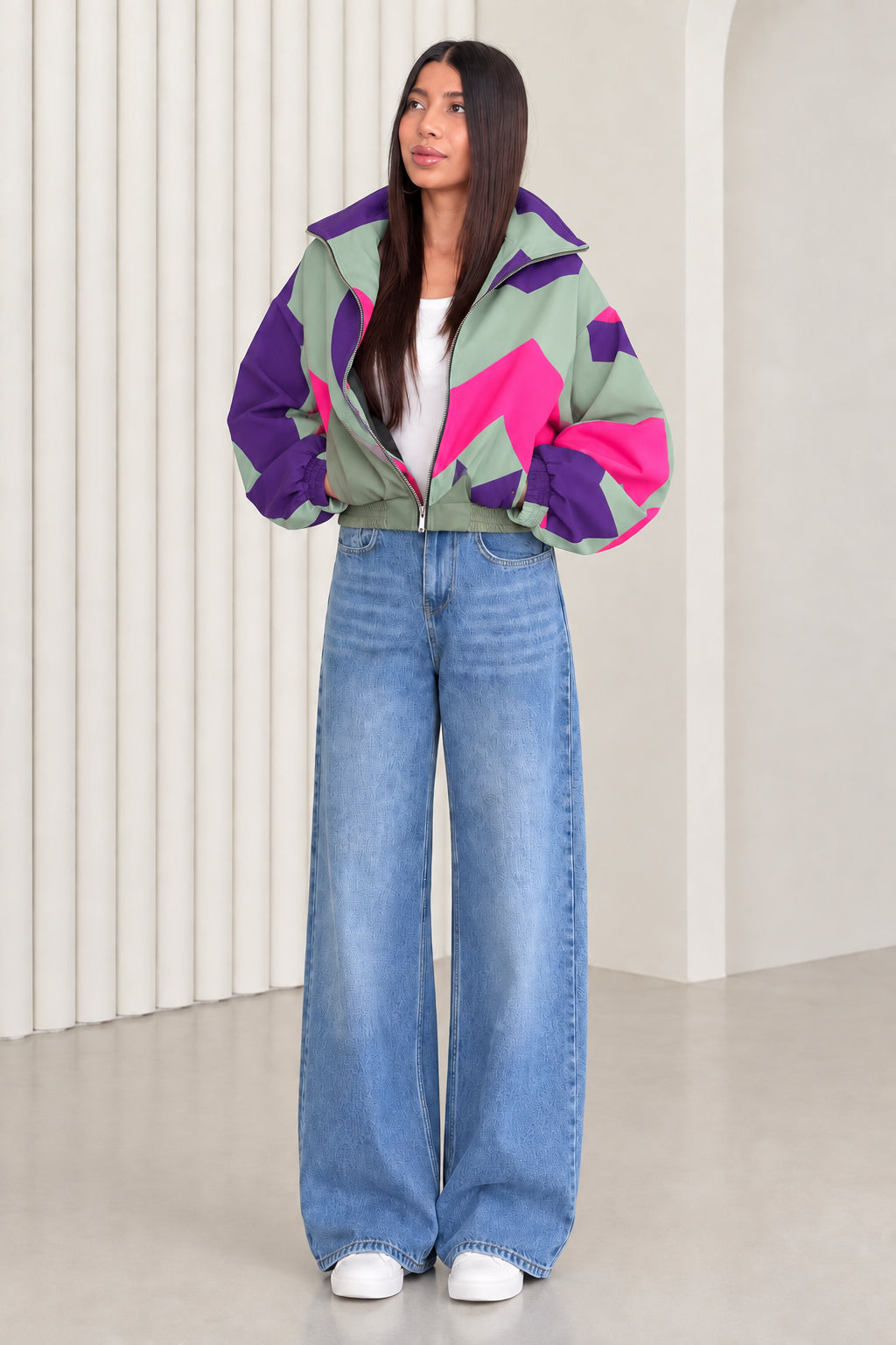 Woman wearing sage green and purple geometric colorblock windbreaker jacket