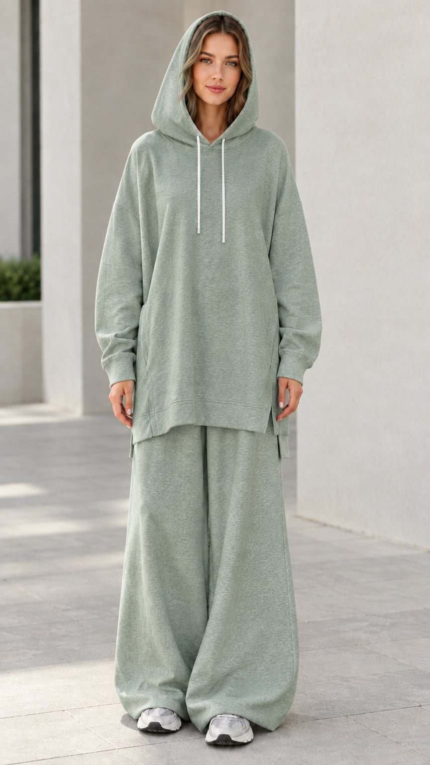 Woman wearing sage green oversized tunic hoodie and wide-leg sweatpants tracksuit