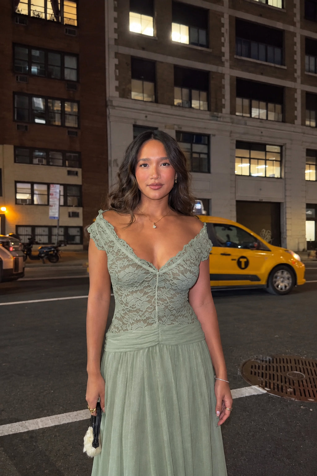 Woman wearing sage green lace V-neck evening maxi dress