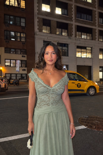 Woman wearing sage green lace V-neck evening maxi dress