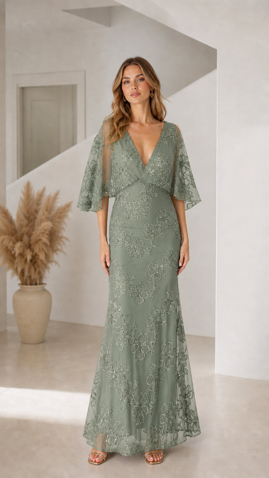 Front view of woman wearing sage green floral sequin flutter sleeve maxi dress