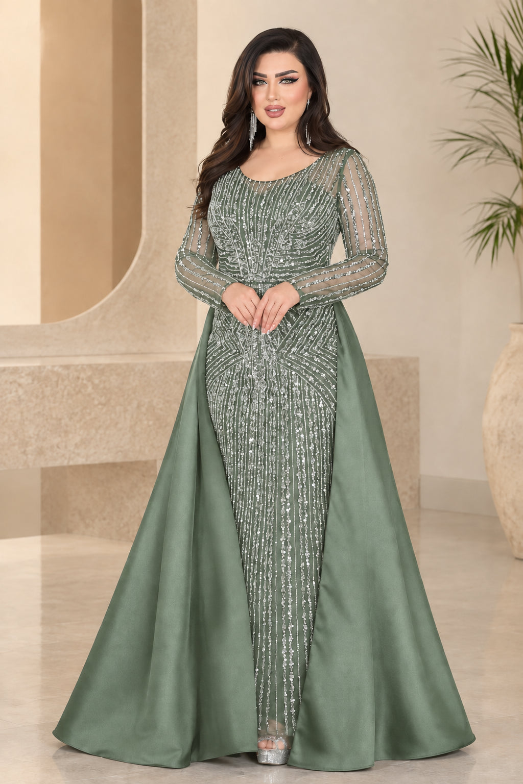Sage green beaded evening gown with long sleeves and floor-length overskirt