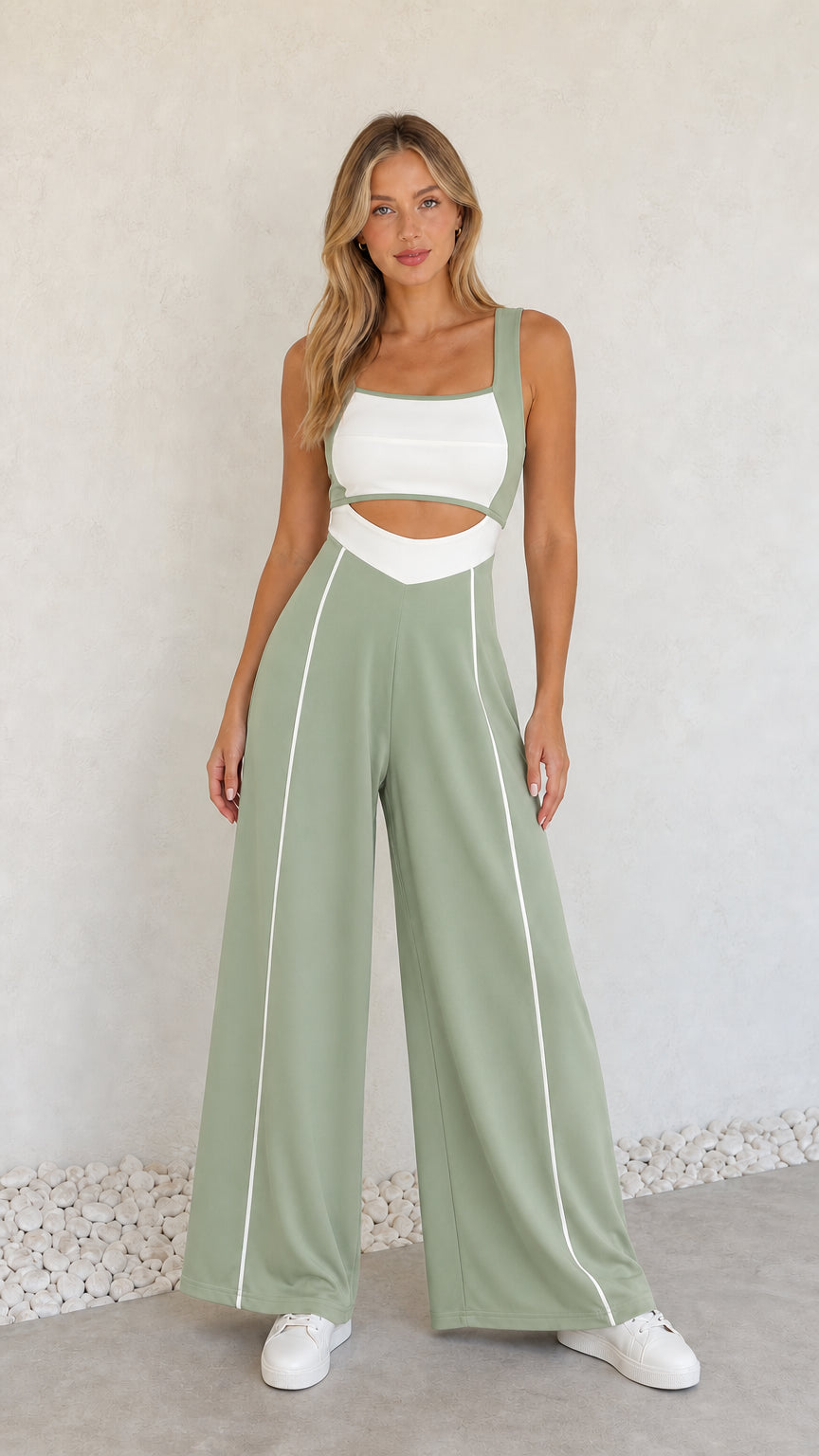 Model wearing sage green colorblock cutout wide-leg jumpsuit with white piping