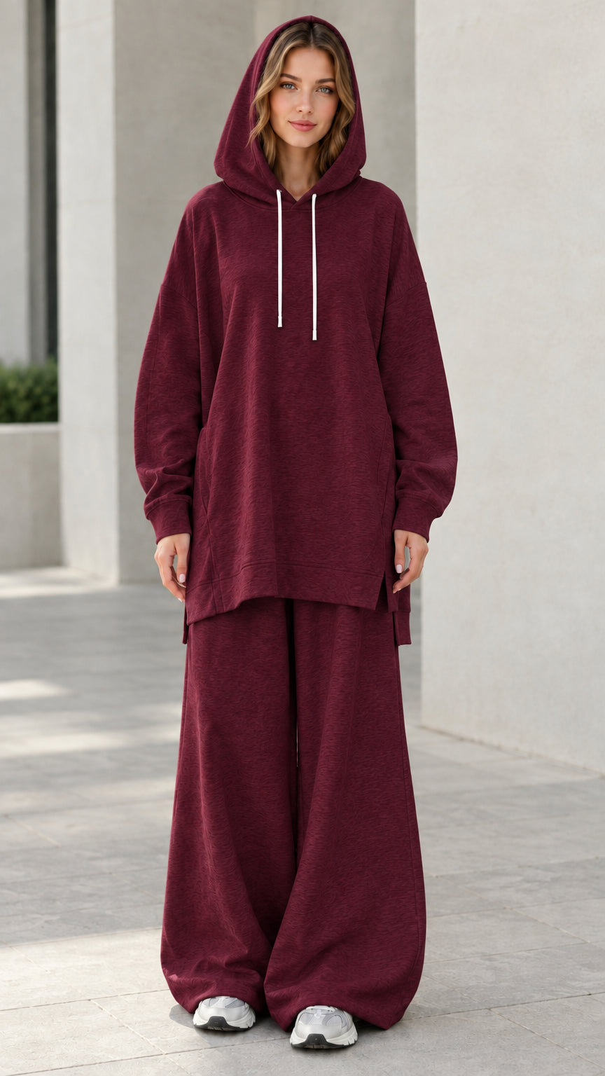 Woman wearing deep burgundy wine oversized hoodie and relaxed wide-leg lounge pants set