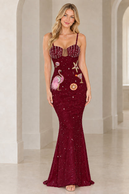 Model wearing burgundy red beaded flamingo motif evening gown