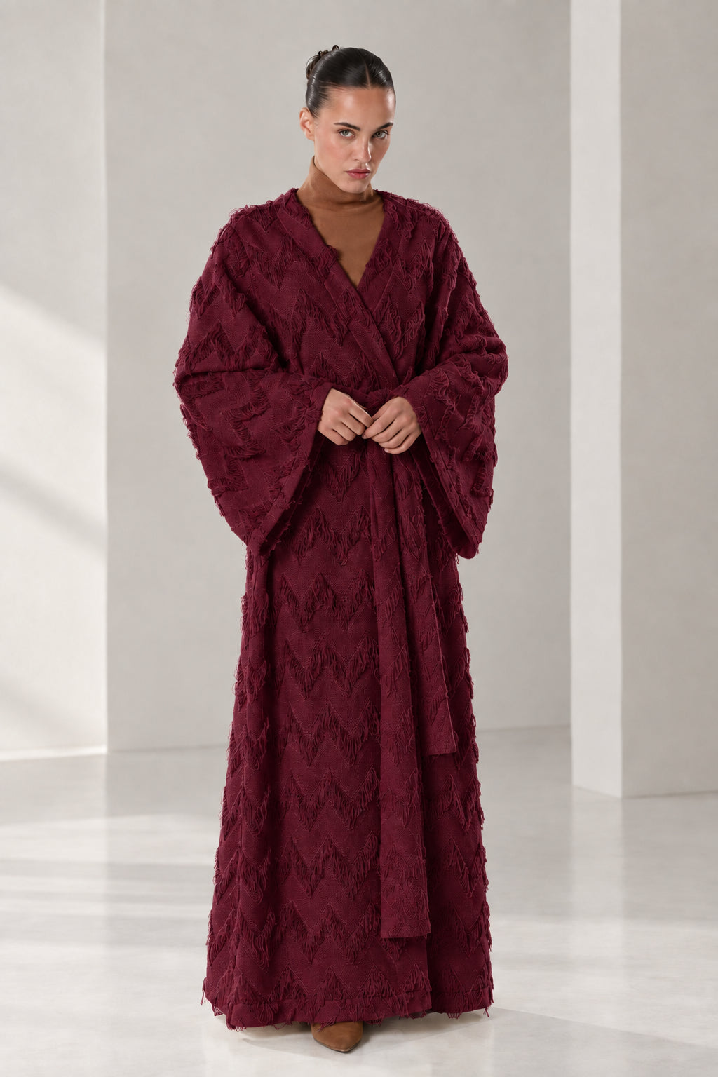 Front full view of woman wearing burgundy wine textured chevron fringe maxi wrap robe