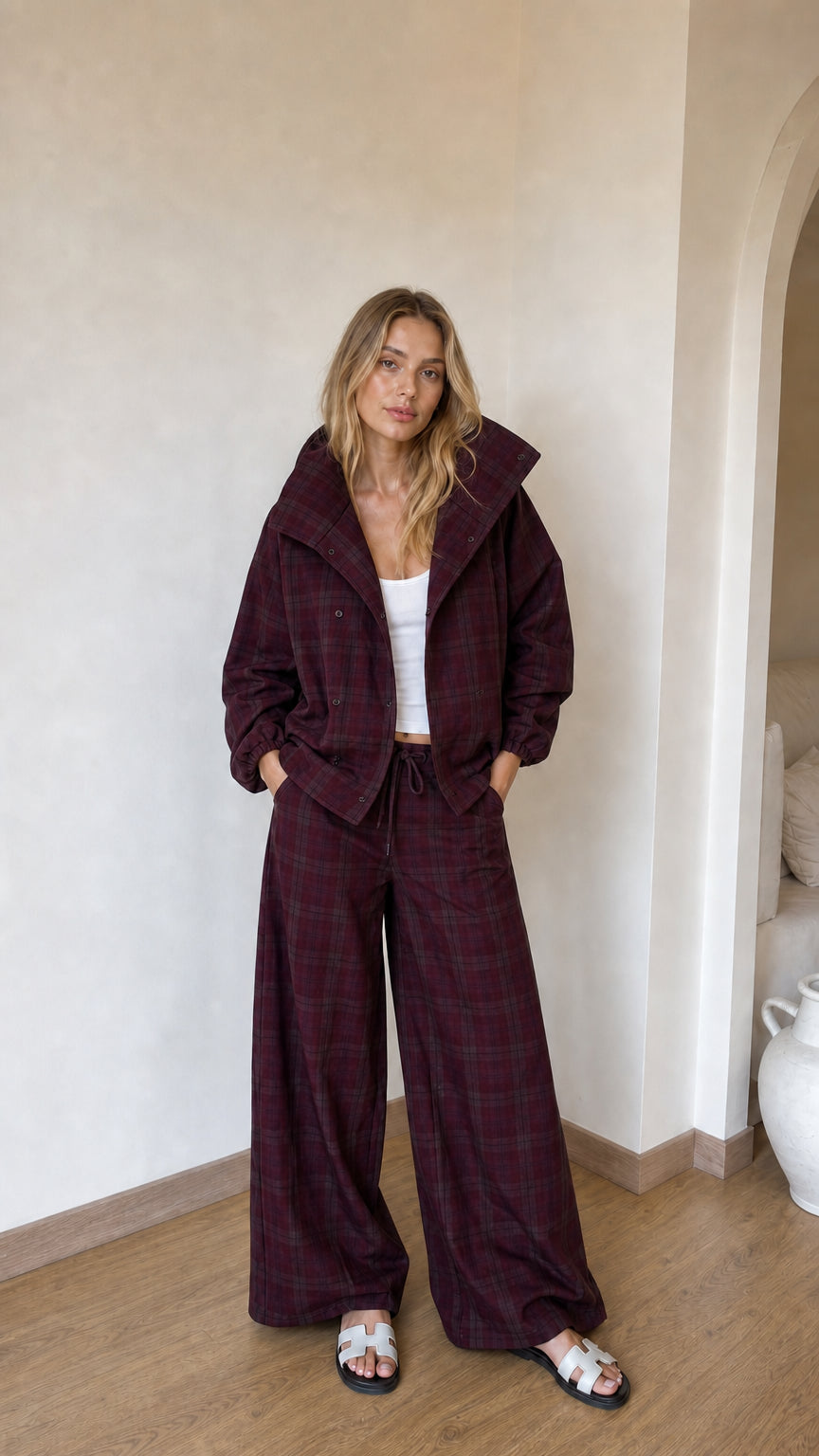 Model wearing burgundy wine plaid jacket and coordinated wide-leg trousers