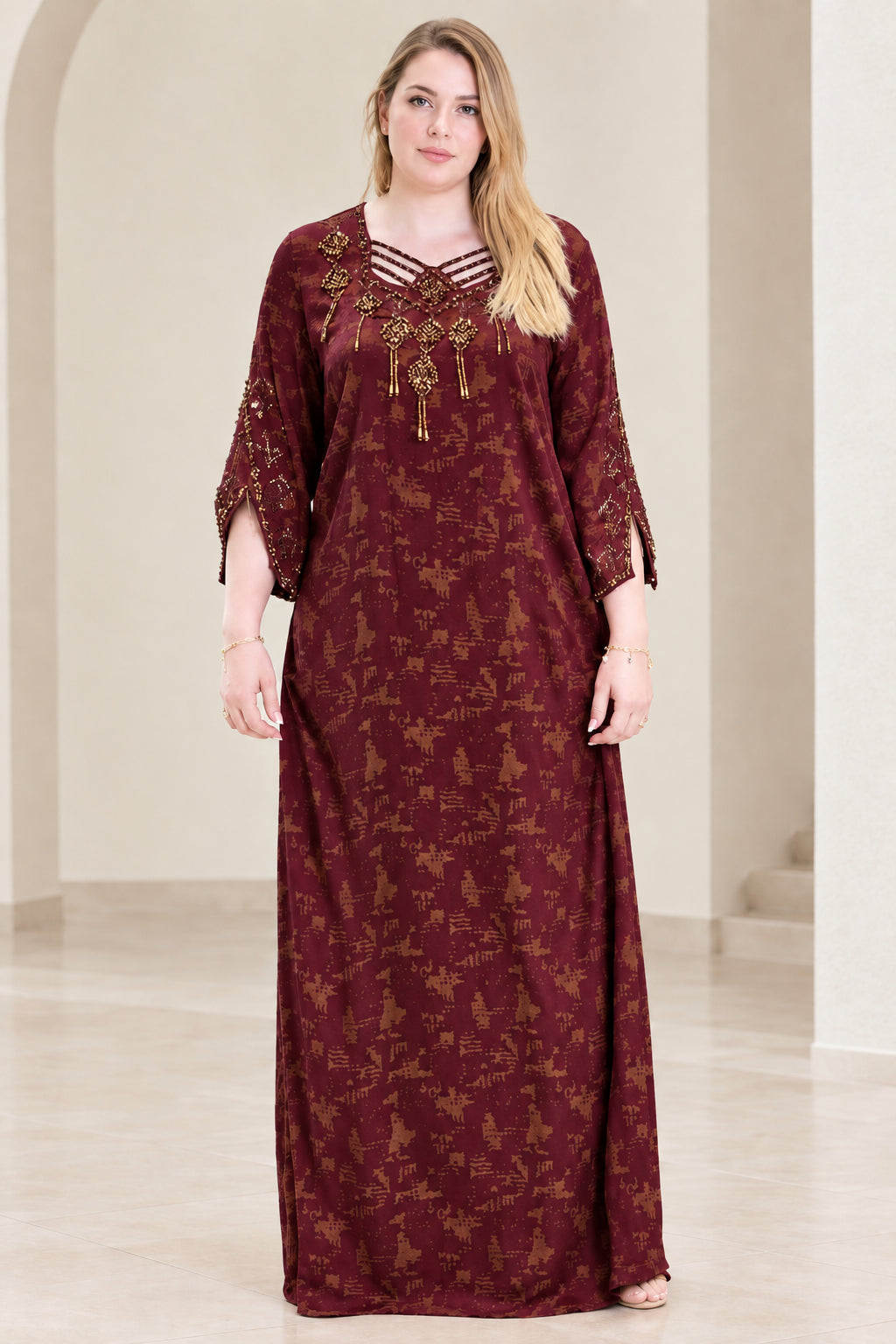 Front view of woman wearing burgundy wine beaded strappy neckline kaftan dress